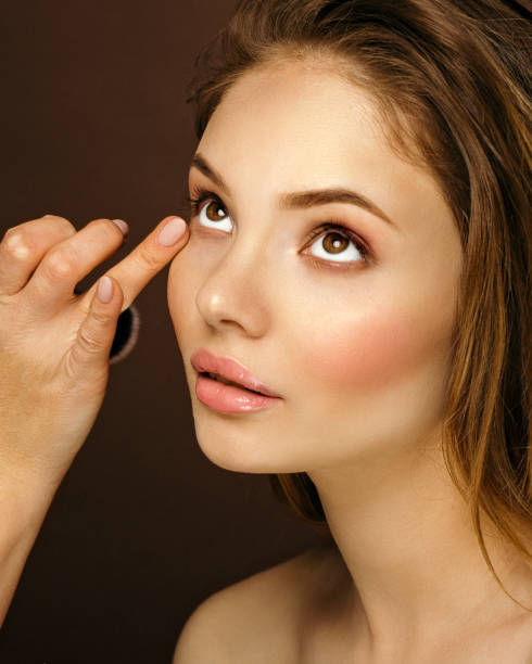 istock Makeup artist applying makeup on a girl 992776874