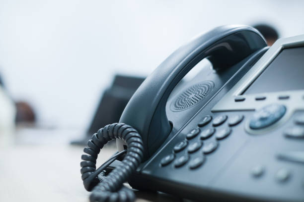 close up soft focus on telephone devices at office desk for customer service support concept close up soft focus on telephone devices at office desk for customer service support concept telephone receiver stock pictures, royalty-free photos & images