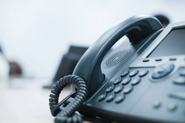 close up soft focus on telephone devices at office desk for customer service support concept close up soft focus on telephone devices at office desk for customer service support concept landline phone stock pictures, royalty-free photos & images