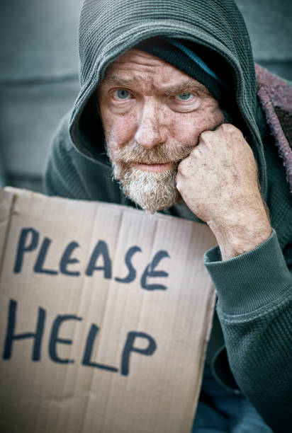 istock Homeless beggar looks at camera resentfully 992782278