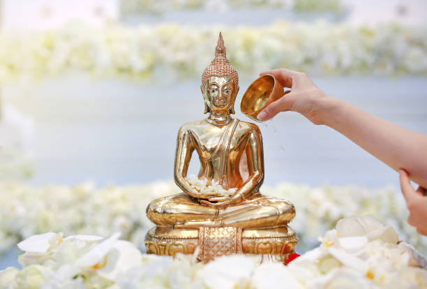 istock People blessing holy water and pay respects to Buddha statue. 992783398