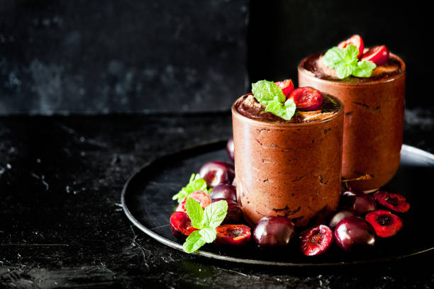 Glasses Of Dark Chocolate Mousse With Organic Cherries