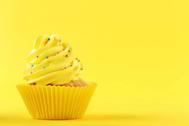 istock Tasty cupcake on a yellow background 992788084