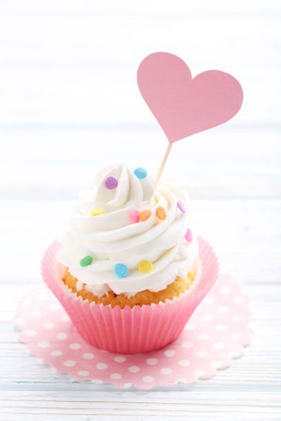 istock Tasty cupcake on a white wooden table 992790910