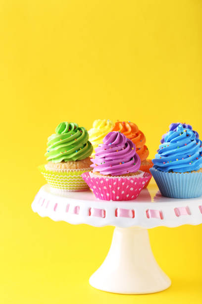 istock Tasty cupcakes on a yellow background 992791170