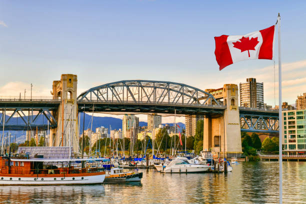 Granville island in Vancouver,Canada Ferry boat docked along in Granville island near Burrard Street Bridge at twilight in Vancouver,Canada granville island stock pictures, royalty-free photos & images