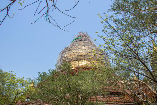 Myanmar: Dhammayazika Pagoda The gold gilded dome of the Dhammayazika Pagoda (Dhamma Ya Zi Ka Pagoda) surrounded in scaffolding and under restoration. dhammayazika pagoda stock pictures, royalty-free photos & images