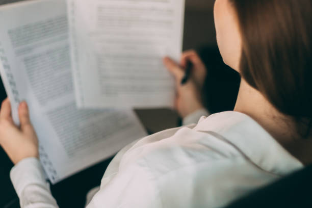istock Close up of businesswoman reading documents. 992806810