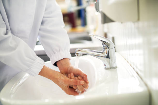 istock Female hands are being washed clean in a bathroom sink. 992810860