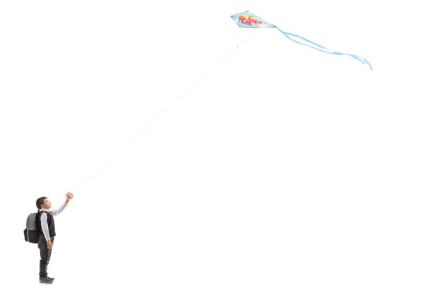 istock Little schoolboy flying a kite 992814872