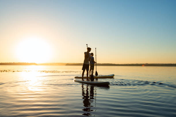 istock Men, friends relax on a SUP boards 992815680