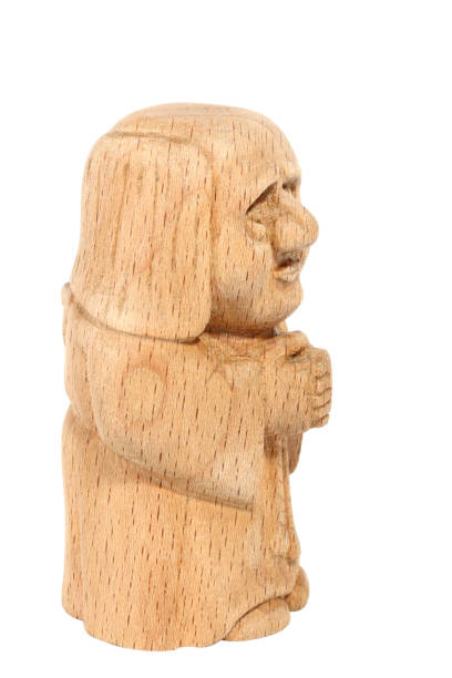 istock Figurine of a Monk carved from beech. Fairytale character. Side view 992823558