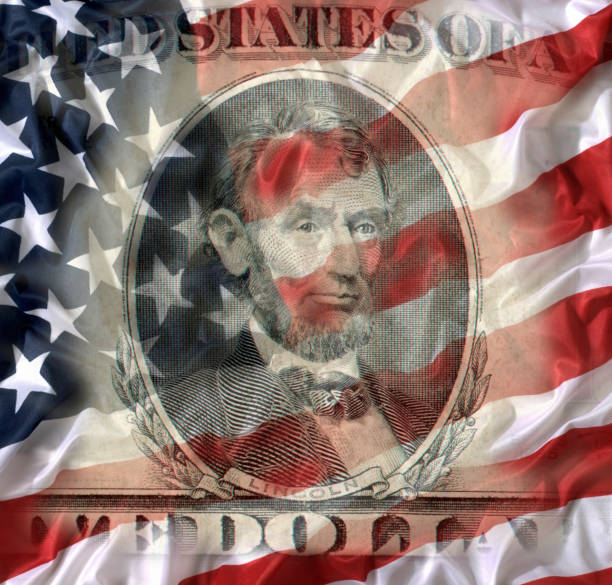 istock FIVE DOLLAR BILL WITH AMERICAN NATIONAL FLAG 992837916
