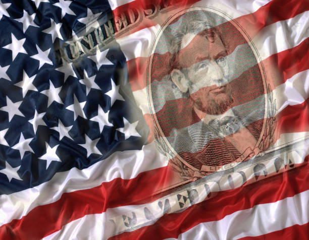 istock FIVE DOLLAR BILL WITH AMERICAN NATIONAL FLAG 992840338