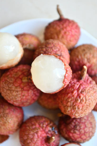 istock Fresh and juicy lychees on neutral background. 992840446