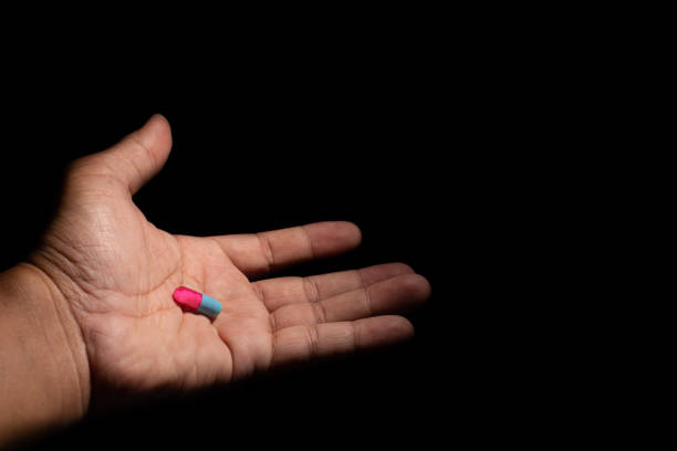 istock hand holding pill of capsule 992840524