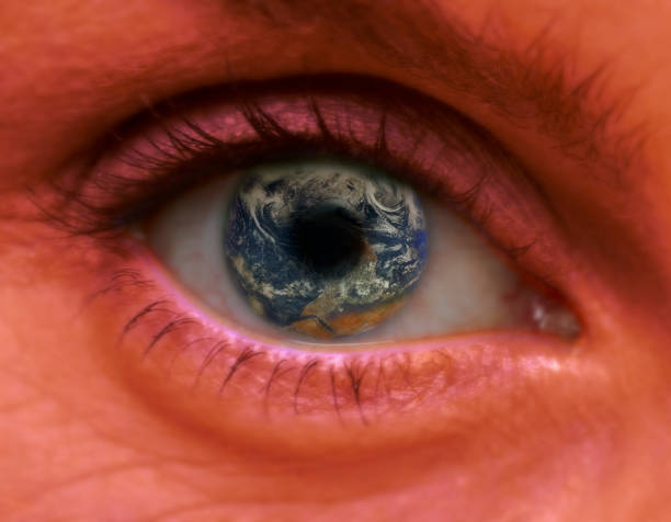istock FEMALE EYE WITH PLANET EARTH IN PUPIL 992841500