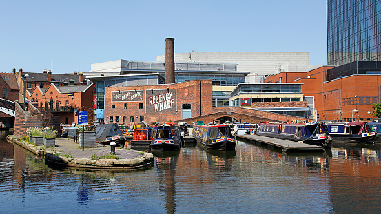 Birmingham, UK: June 29, 2018: Regency Wharf at Gas Street Basin. The restored canal system in Birmingham central is a national heritage landmark and where the Worcester and Birmingham canals meet.