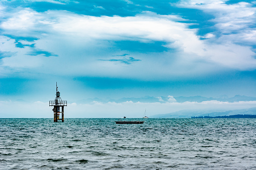 Lake Constance with lighthouse and cloudy sky in summer