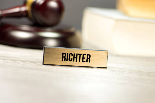 istock A judge's hammer, law books and a table display with the imprint Richter 992851152
