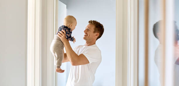 istock Loving father playing with little son at home 992851600