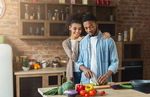 istock Loving african-american couple cooking in loft kitchen 992854890