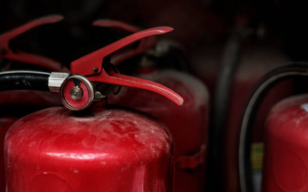 istock Closeup of red fire extinguishers 992860098