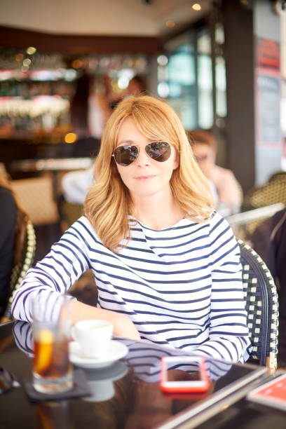 istock Smiling woman relaxing at coffee shop 992860484