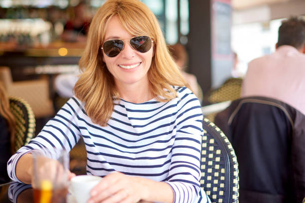 istock Attractive woman sitting at cafe 992860496