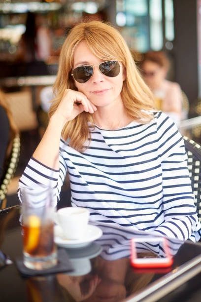 istock Smiling woman relaxing at coffee shop 992860526