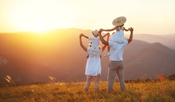 istock Happy family: mother, father, children son and daughter on sunset 992863014