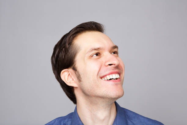 istock Close up smiling friendly young man looking to the side 992863194