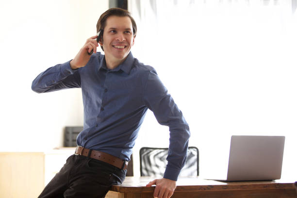 istock happy businessman man on phone call leaning on desk 992863210