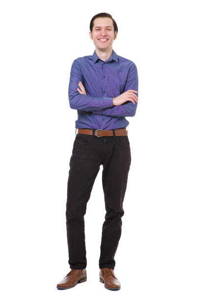 istock Full length smiling young man standing with arms crossed on white background 992863234
