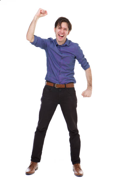 istock Full length ecstatic young man standing with fist raised 992863254