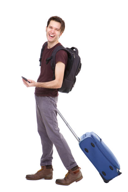 istock Full length handsome young man with suitcase and backpack holding phone 992863280