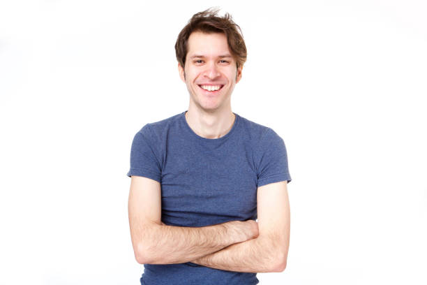 istock confident man standing with arms crossed by white background 992863370