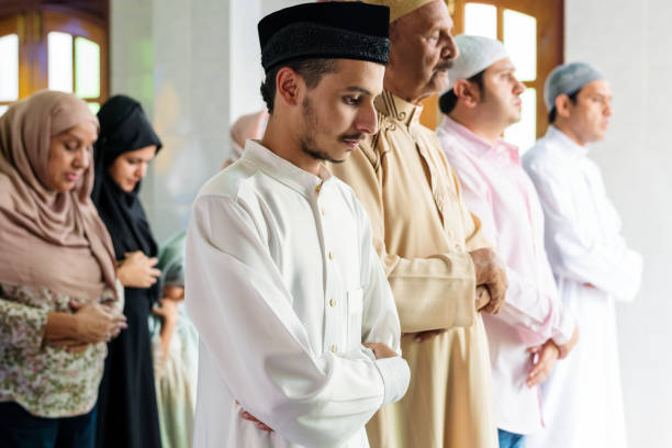 istock Muslim prayers in Qiyaam posture 992866818