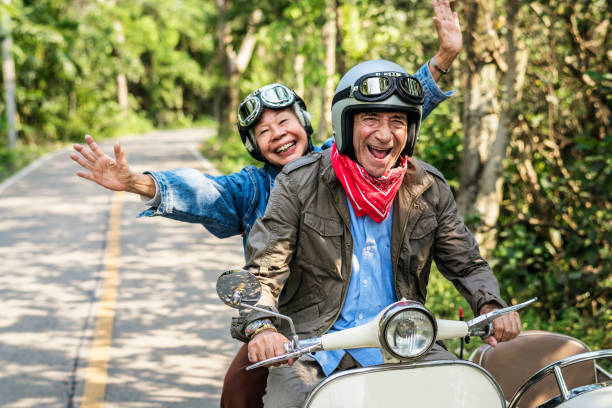 istock Senior couple riding a classic scooter 992867094