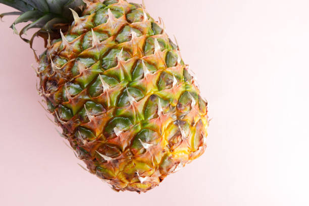 istock Pineapple on a pink background, tropical fruit top view, pineapple in pop art style, vegetarian food in minimalism style, copy space 992867818