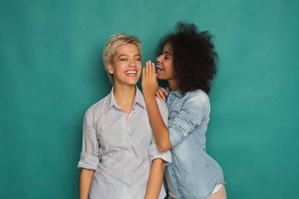 istock Young woman telling her friend some secrets 992867942