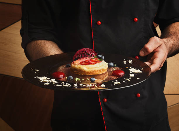 istock Lemon cheesecake with berry spheres served at modern restaurant 992870660