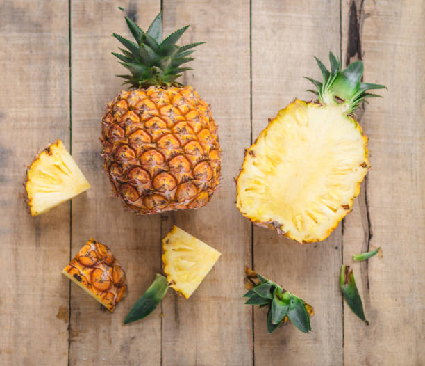 istock fruit pineapple On the wood background 992872138