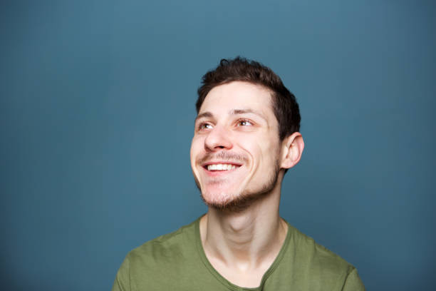 istock portrait of happy young man looking up 992875720