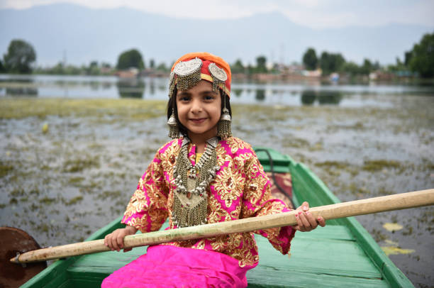 Srinagar, Jammu and Kashmir, India; October 11, 2024: House boats at Dal Lake and the beautiful mountain range in the background in the city of Srinagar Kashmir, India.