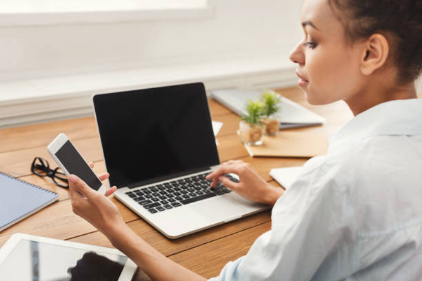 istock Young woman using laptop with blank screen 992879722