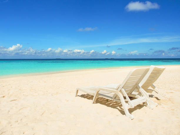 istock White beach chairs on the beach in Maldives. 992879738