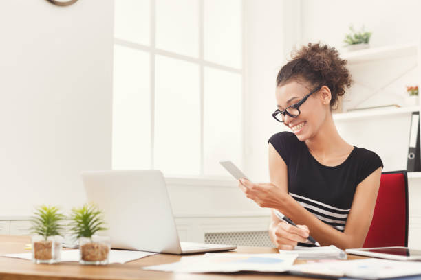 istock Young business woman working on phone 992879748