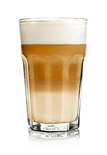 Hot milk coffee or latte macchiato glass, isolated on white. Italian coffee with milk and layers. Gourmet coffee.