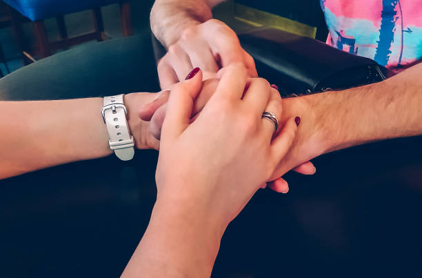 istock Lovers hold hands in close-up 992880250